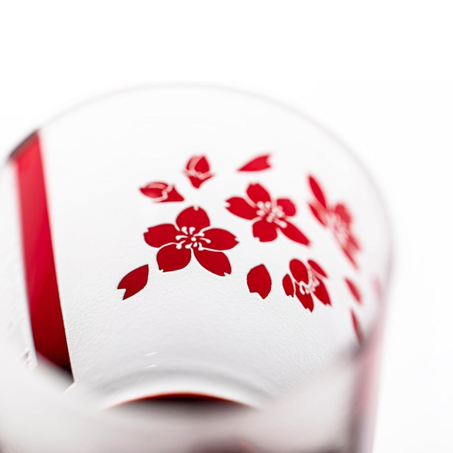 Top view of the whiskey glass featuring red sakura (cherry blossom) flower details inside the rim.