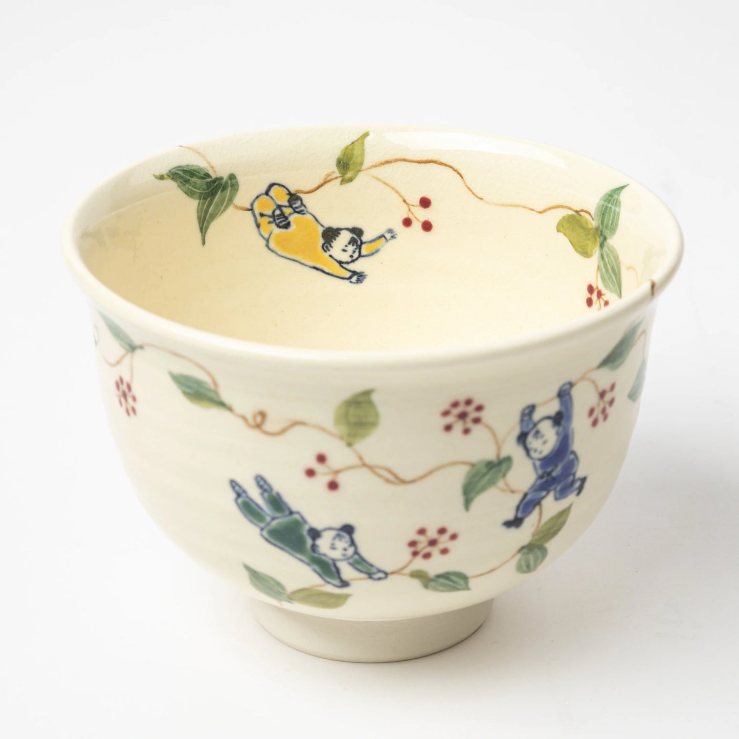 Top-down view of the Karako and Sankirai Matcha Bowl, showing Karako children in yellow and blue frolicking among hand-painted vines.