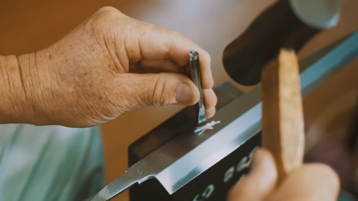 Close up look of Yamawaki Knives Artisan's hand who is engraving the name into Yanagiba Knife