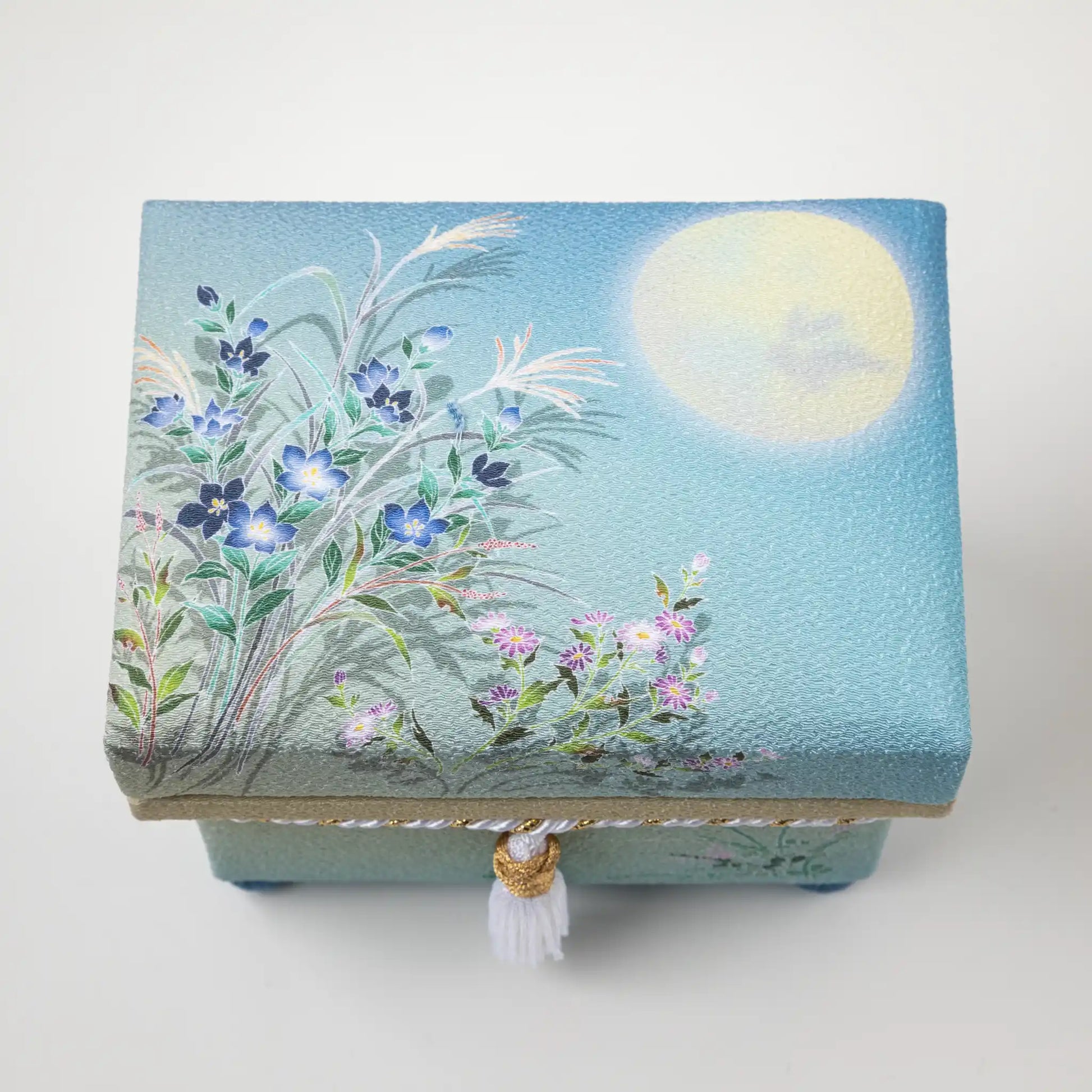 Top view of the Kaga Yuzen Autumn Night Accessory Box lid, featuring an intricate painting of a serene autumn night with blooming flowers and a soft, glowing moon.