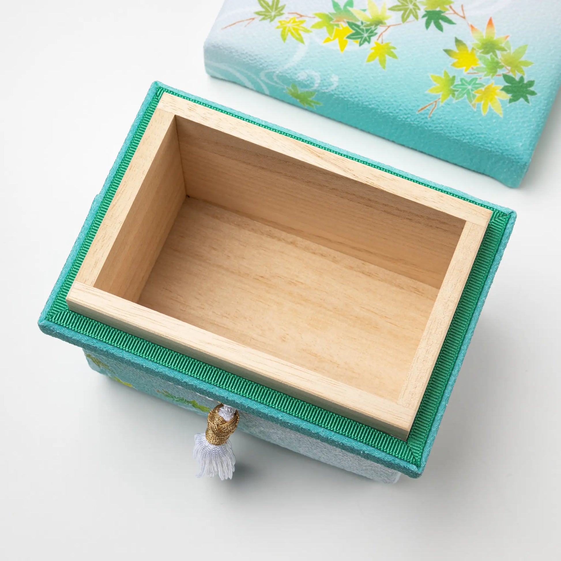 Interior view of the Kaga Yuzen Maple Leaf Accessory Box, showcasing its empty wooden compartment with a removable lid featuring a maple leaf design.