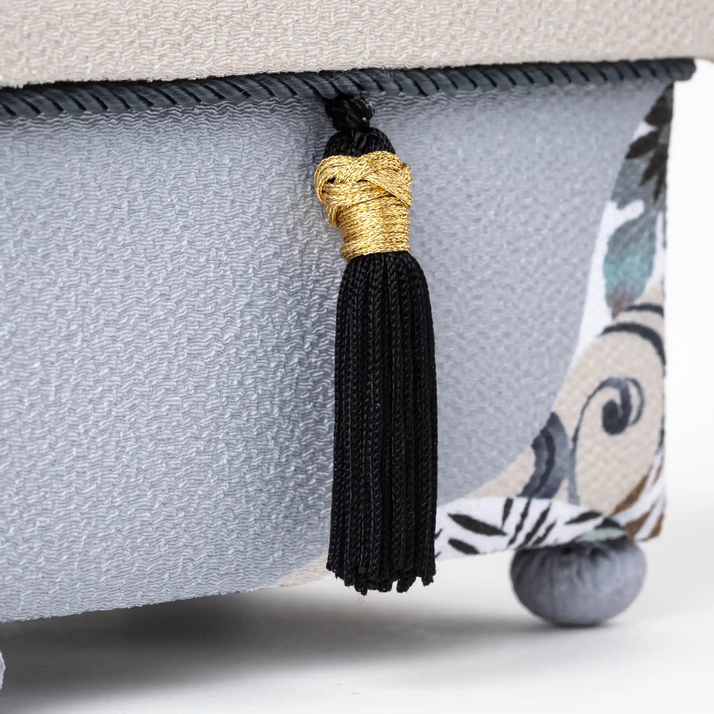 Close-up of the black tassel on the Kaga Yuzen Michinaga Accessory Box, accented with gold detailing and black and white floral motifs on the side."