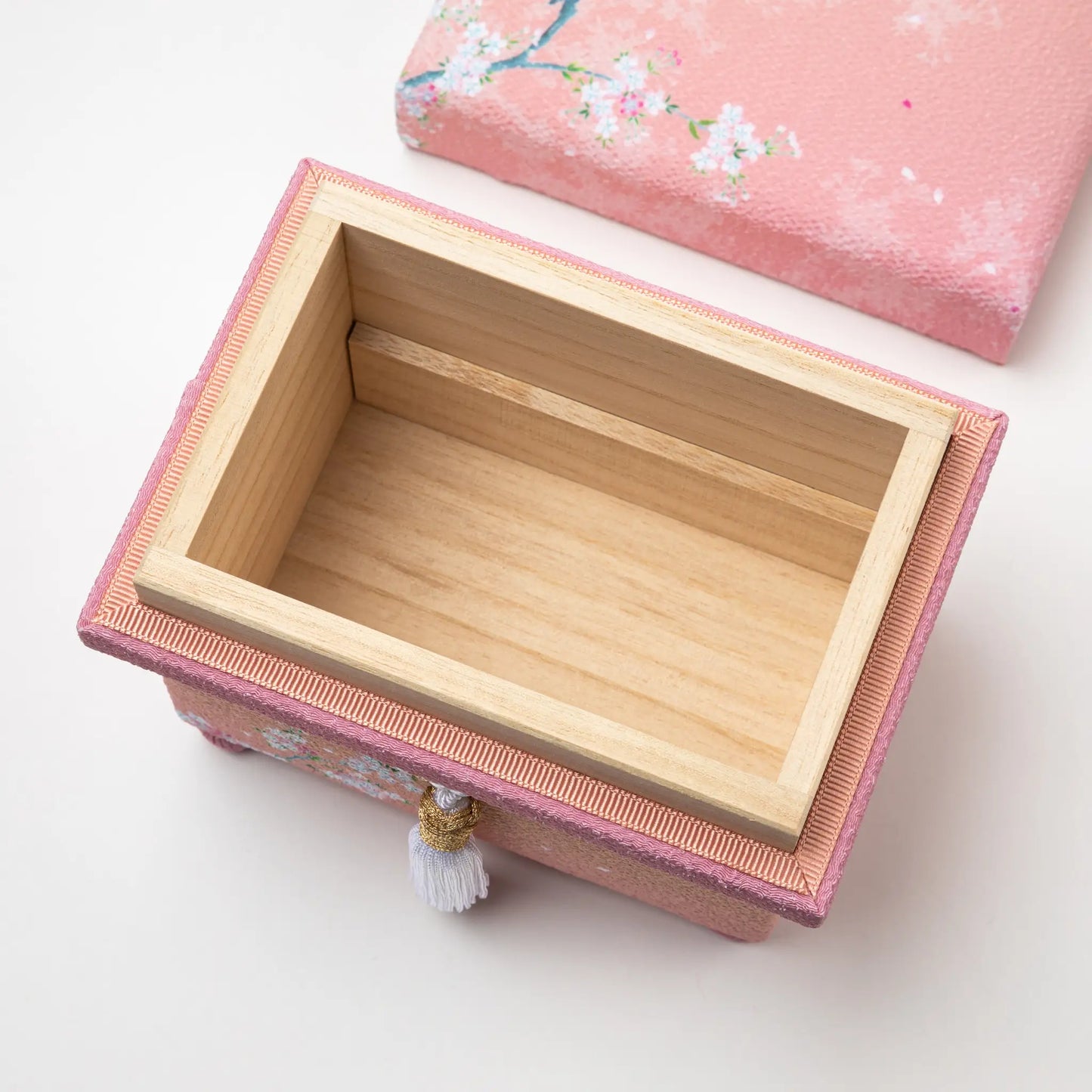 Top-down view of the open hisatsune YUZEN Kaga Yuzen Sakura accessory box, showing the empty wooden compartment inside.