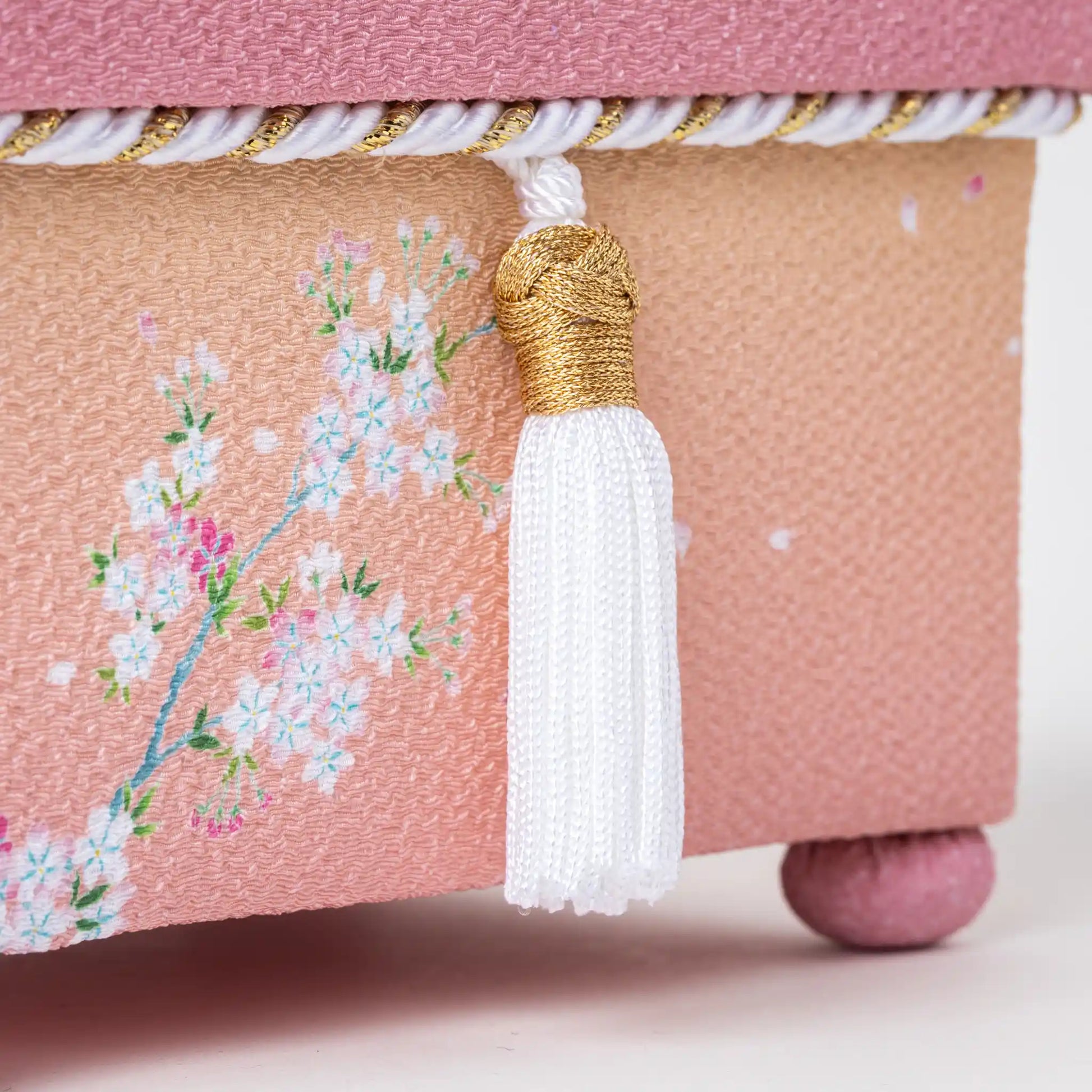 Detailed view of the white tassel and sakura pattern on the hisatsune YUZEN Kaga Yuzen Sakura accessory box, highlighting the gold and white braided trim.