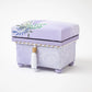 Side angle view of the Kaga Yuzen Wisteria Accessory Box, highlighting the detailed floral design and a neatly crafted tassel.