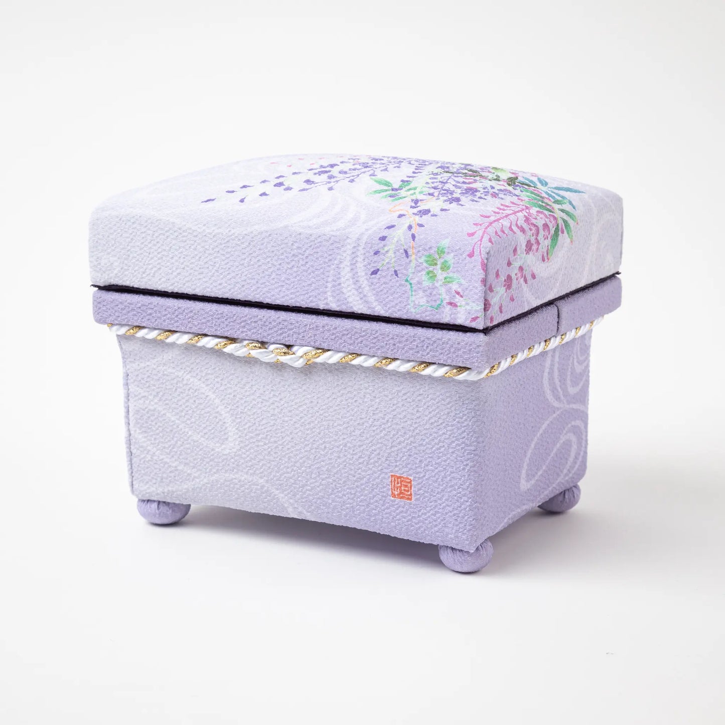 Back view of the Kaga Yuzen Wisteria Accessory Box, adorned with a beautiful purple and green wisteria design on a lavender background, with a decorative white tassel and gold accents.